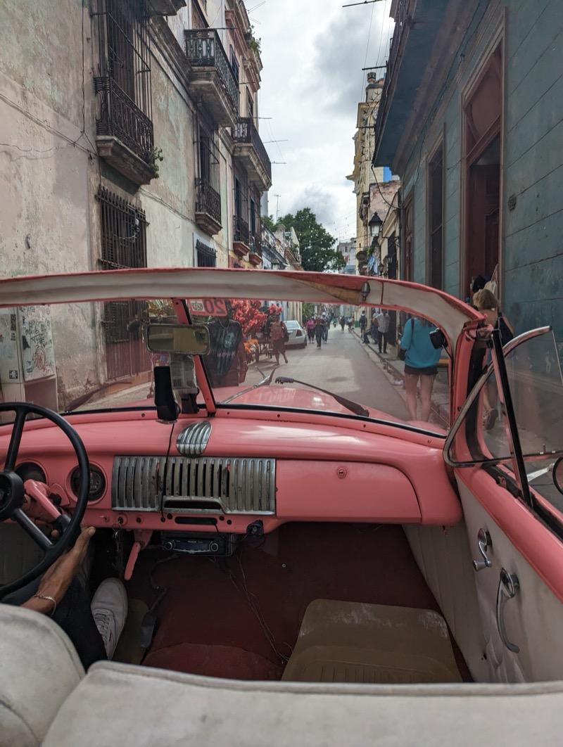 Inside a pink vintage car in Havana